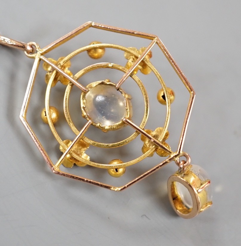 An Edwardian yellow metal and two stone oval cabochon moonstone set open work octagonal drop pendant, 0verall 42mm, gross weight 2.5 grams.